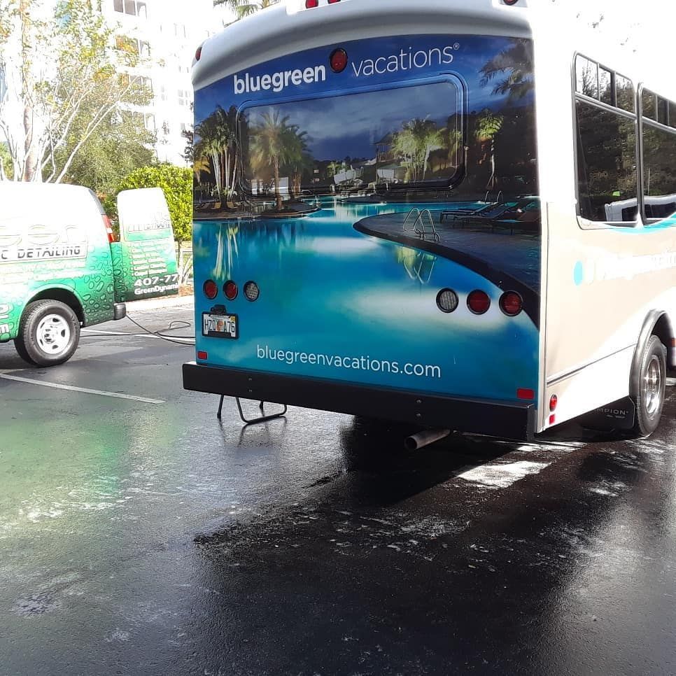A bluegreen vacations bus is parked in a parking lot