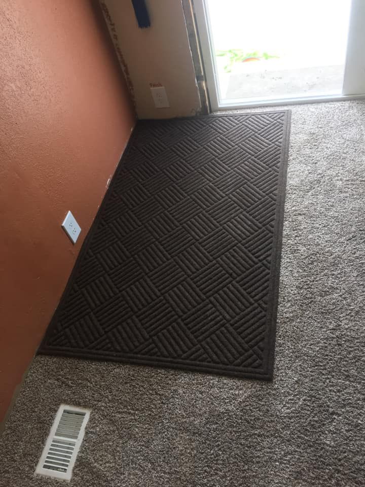 Open truck interior filled with stacked tires, tire changing machine, tools, and a ladder, outdoors.