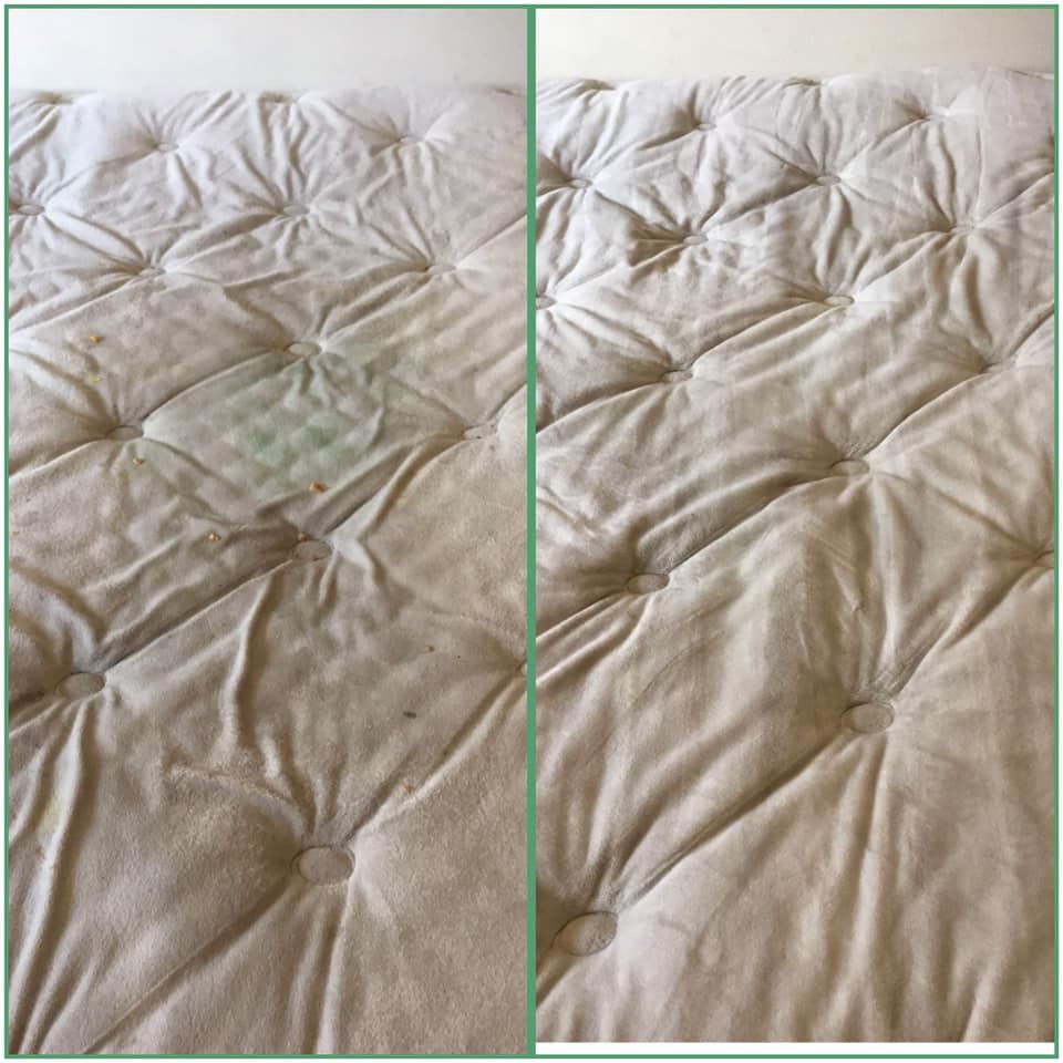 Red semi-truck in a dimly lit garage; a person stands near a lift.