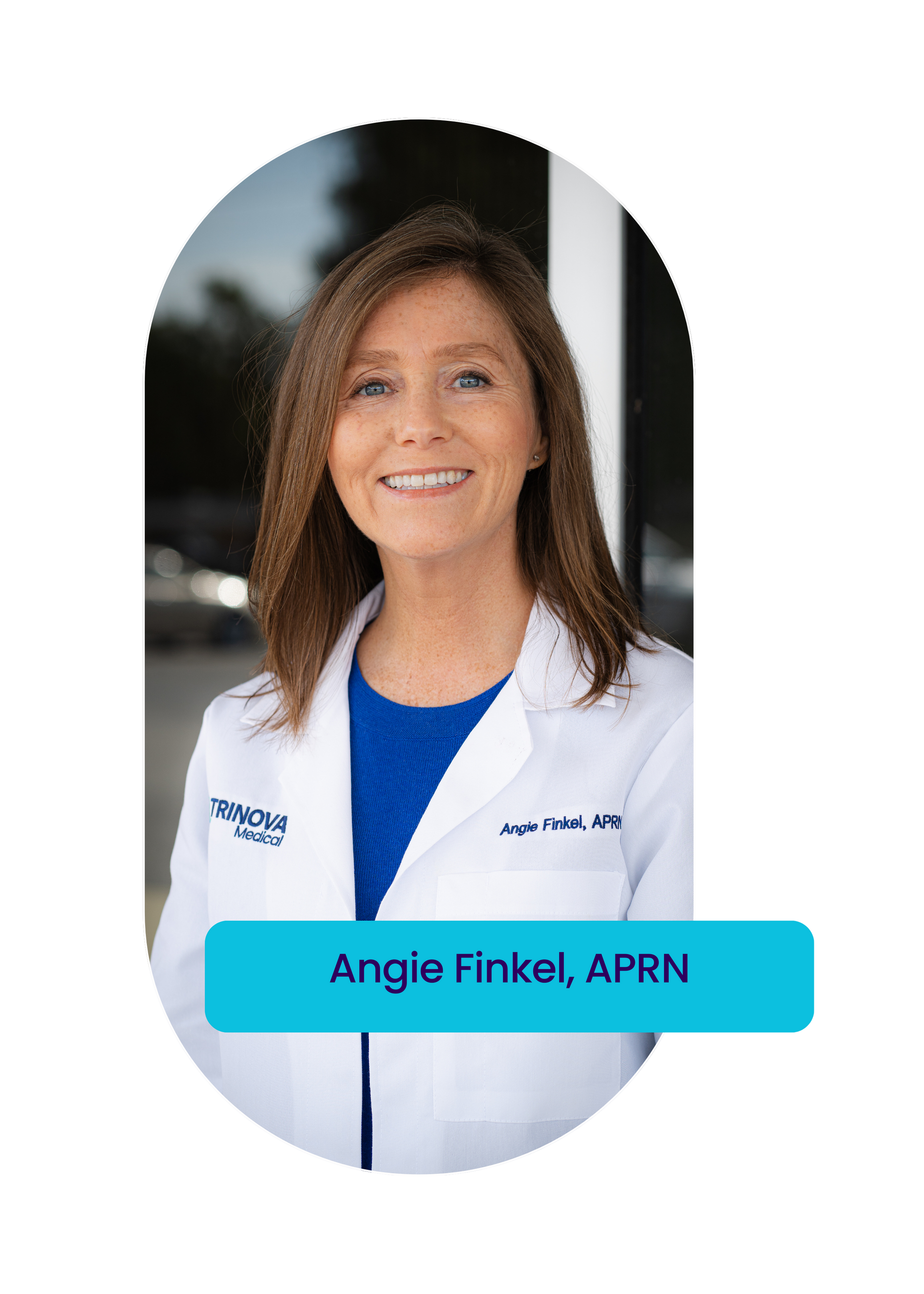 A woman in a white lab coat is smiling for the camera.