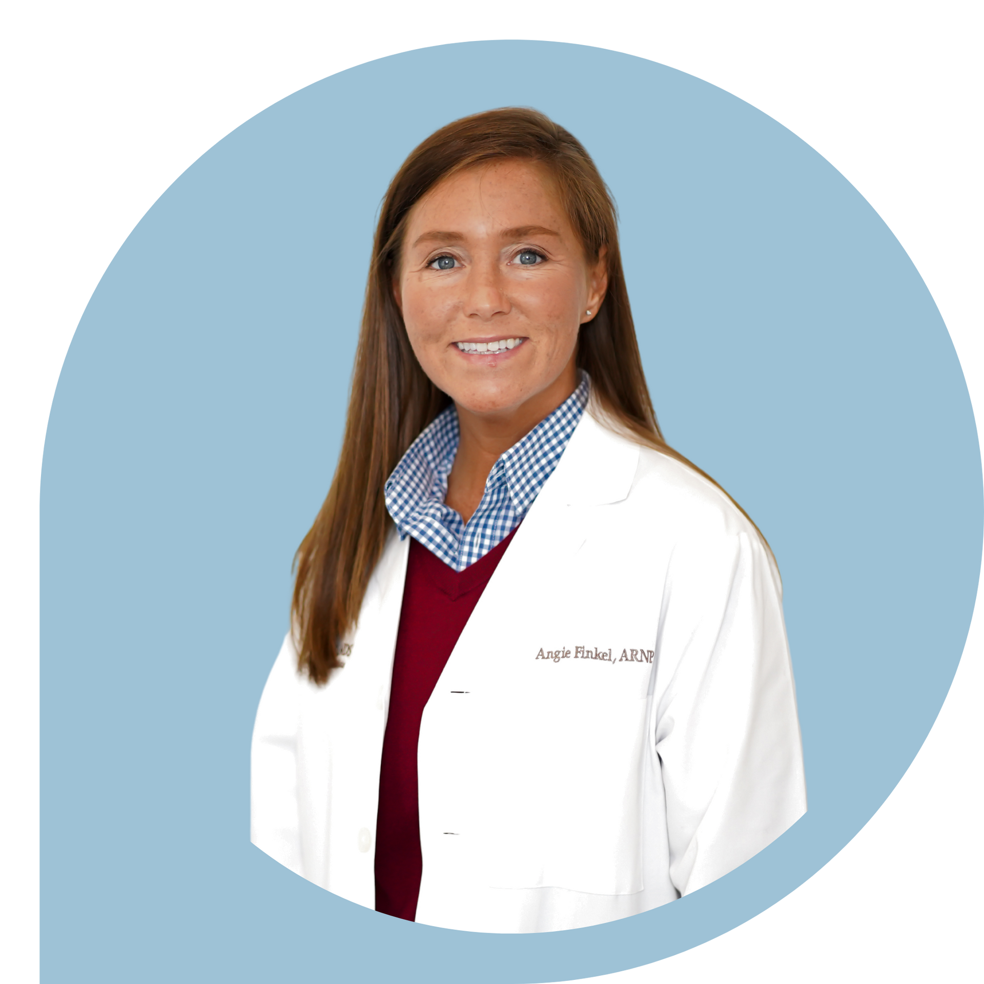 A woman in a white lab coat is smiling for the camera.