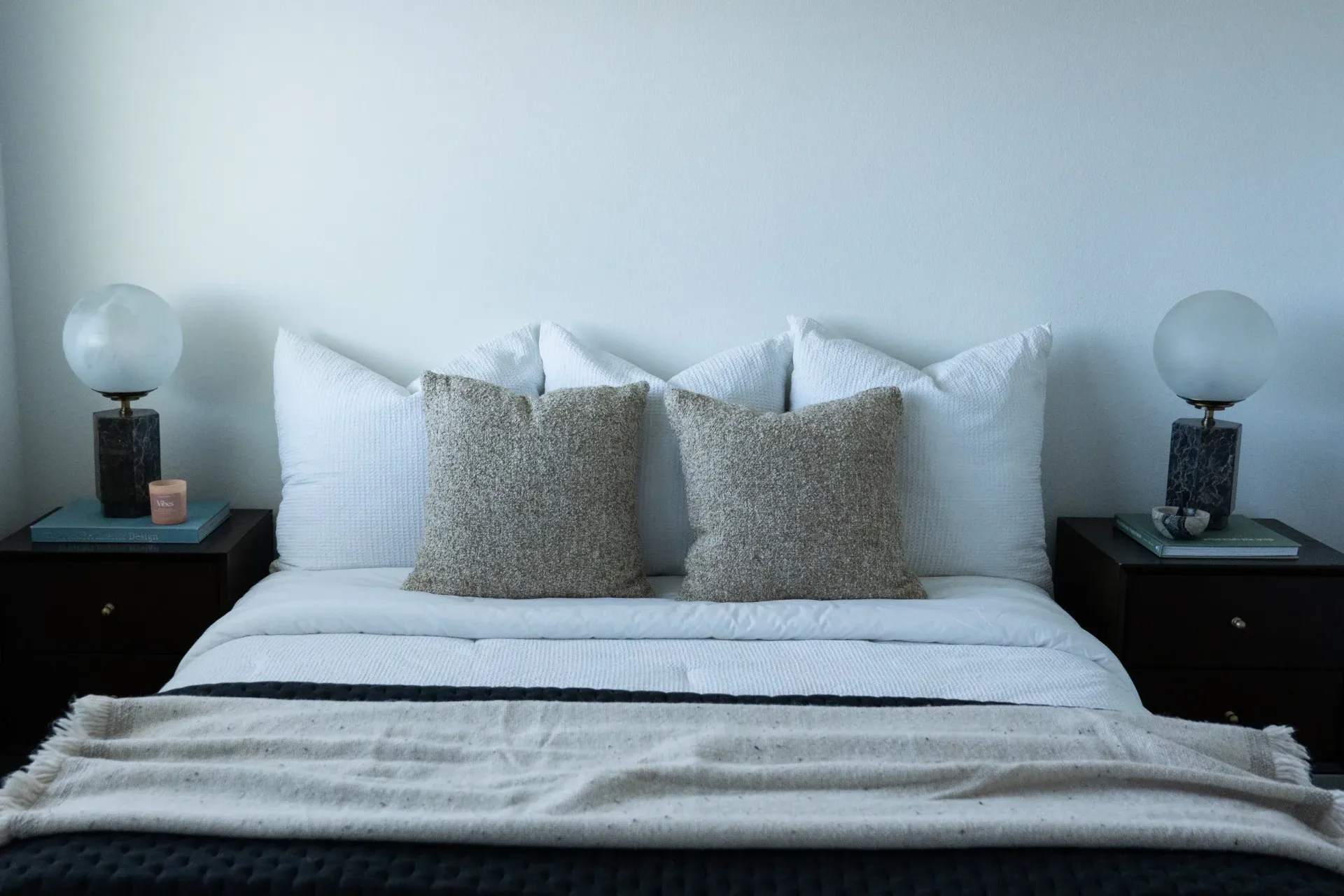 Bedroom with bed, pillows, lamps, and nightstands.