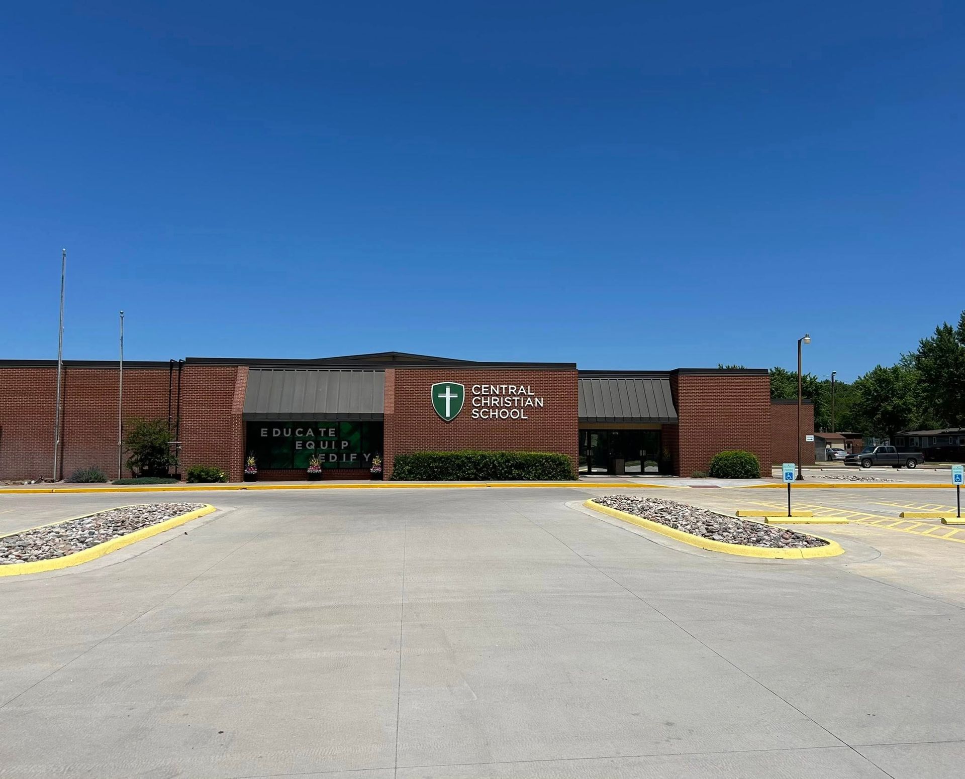 A large brick building with a green cross on it