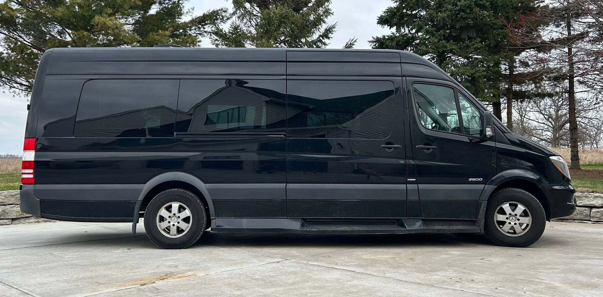 A black van is parked in a parking lot.