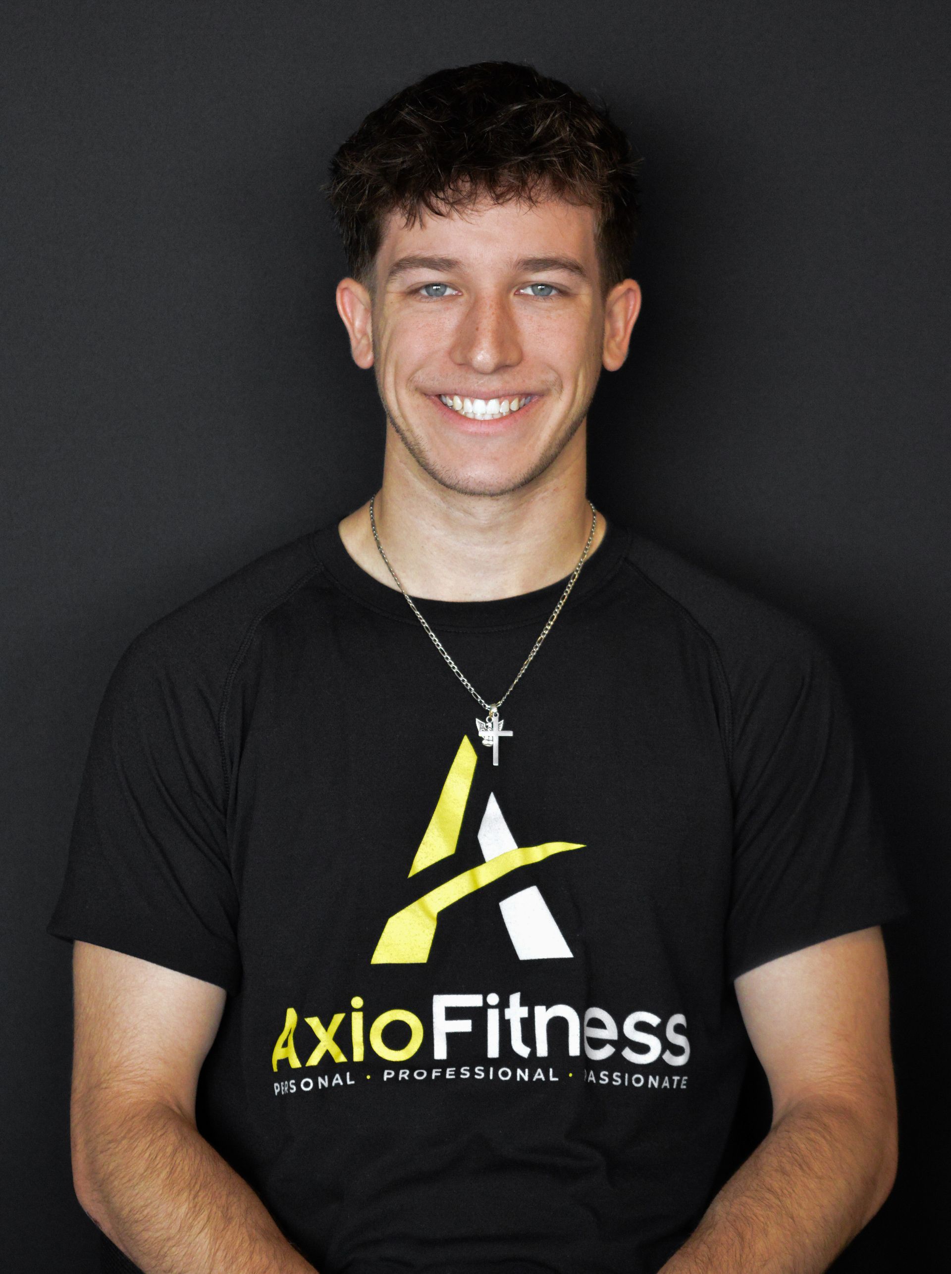 Smiling young man wearing a black t-shirt with a yellow