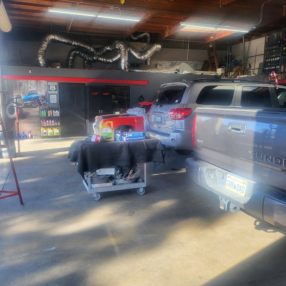 A toyota truck is parked in a garage with other cars