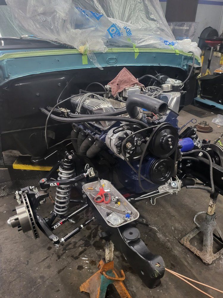 A car engine is being worked on in a garage.