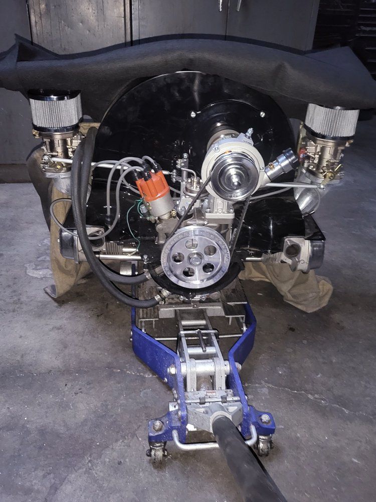 A black engine is sitting on a blue jack