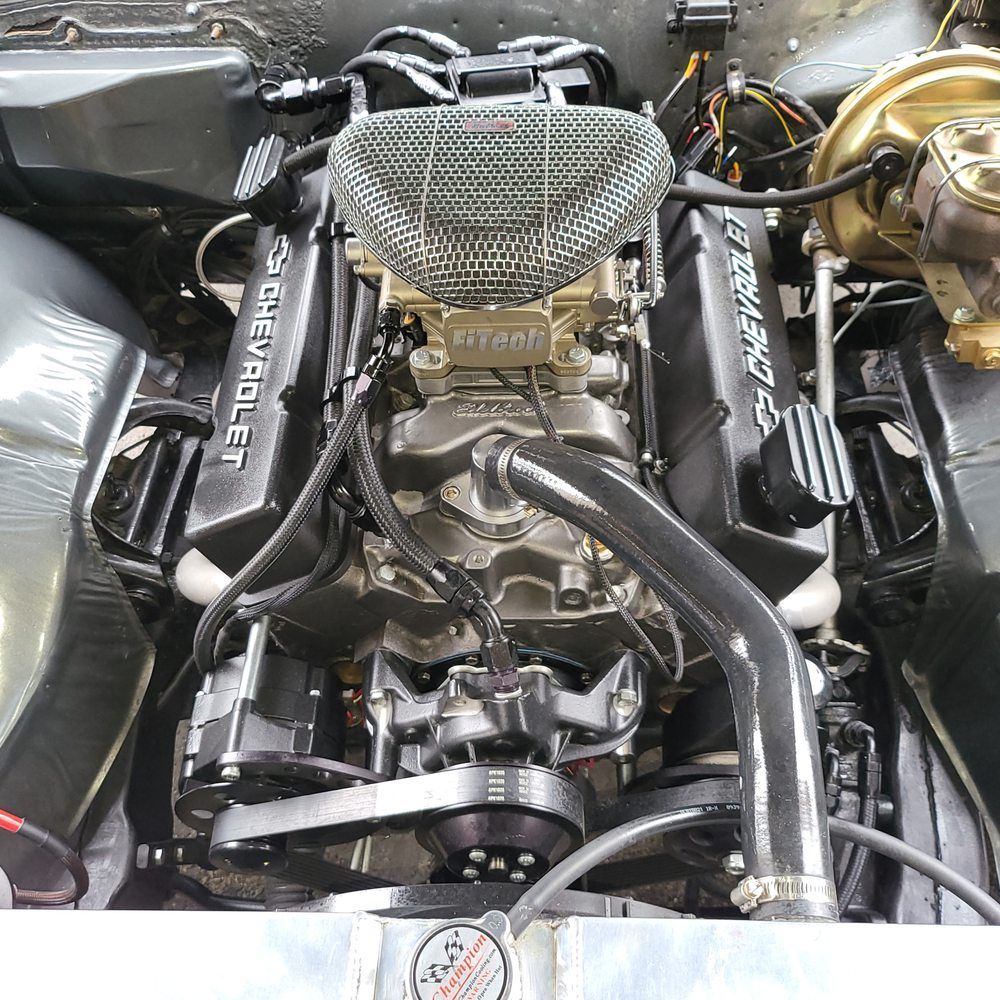 A close up of a chevrolet engine in a car