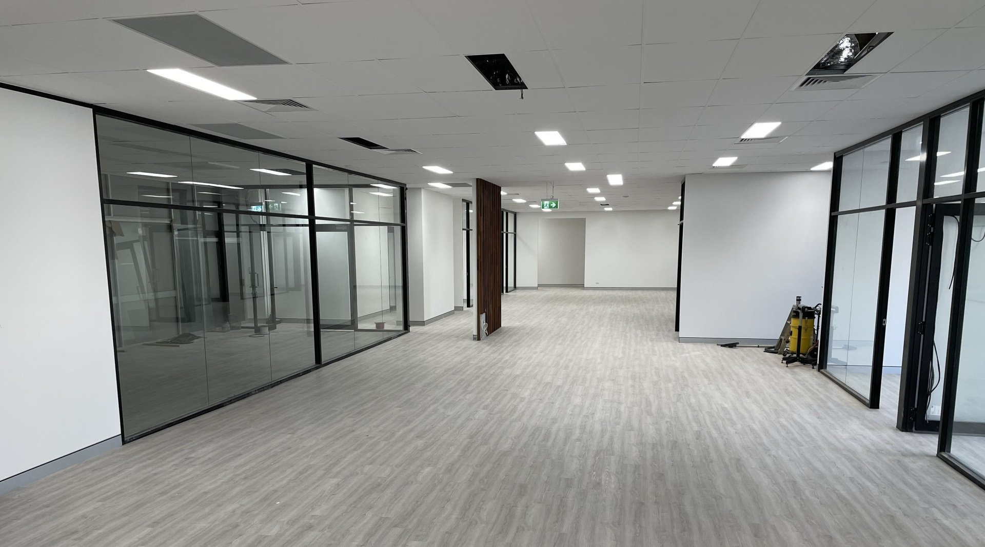 A Large Empty Room with A Lot of Windows and A Vacuum Cleaner — Completely Plastered North Coast in Goonellabah, NSW