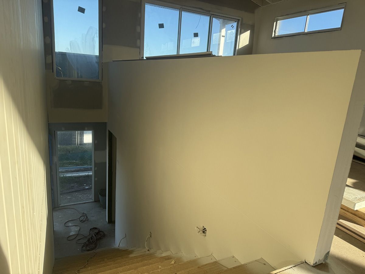 A Staircase in A House Under Construction with A White Wall — Completely Plastered North Coast in Goonellabah, NSW