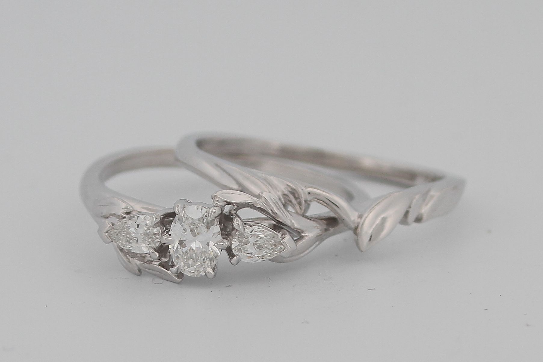 A close up of a diamond ring on a table.