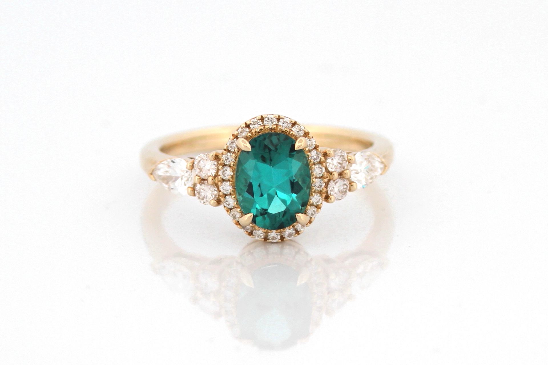 A ring with a flower and a ruby on it