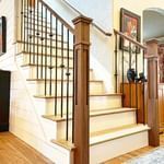 Worker man staining wood floors