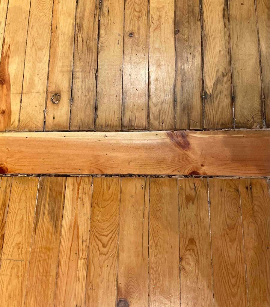 Hardwood flooring with large, unattractive gaps between boards