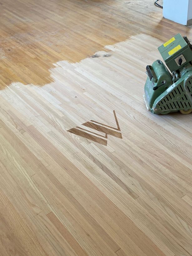 Walnut Hardwood logo stain on wood floors