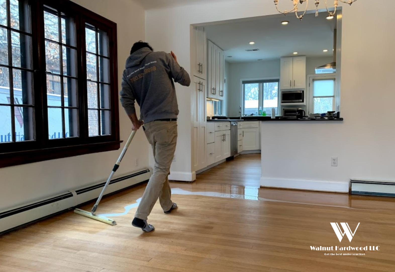 Walnut Hardwood employee staining wood floors