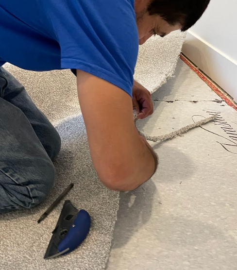 man installing carpet