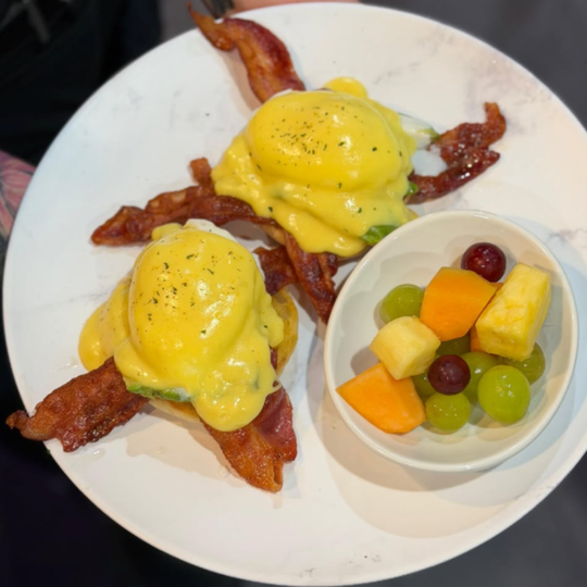 Colorful brunch plate with poached eggs and hollandaise