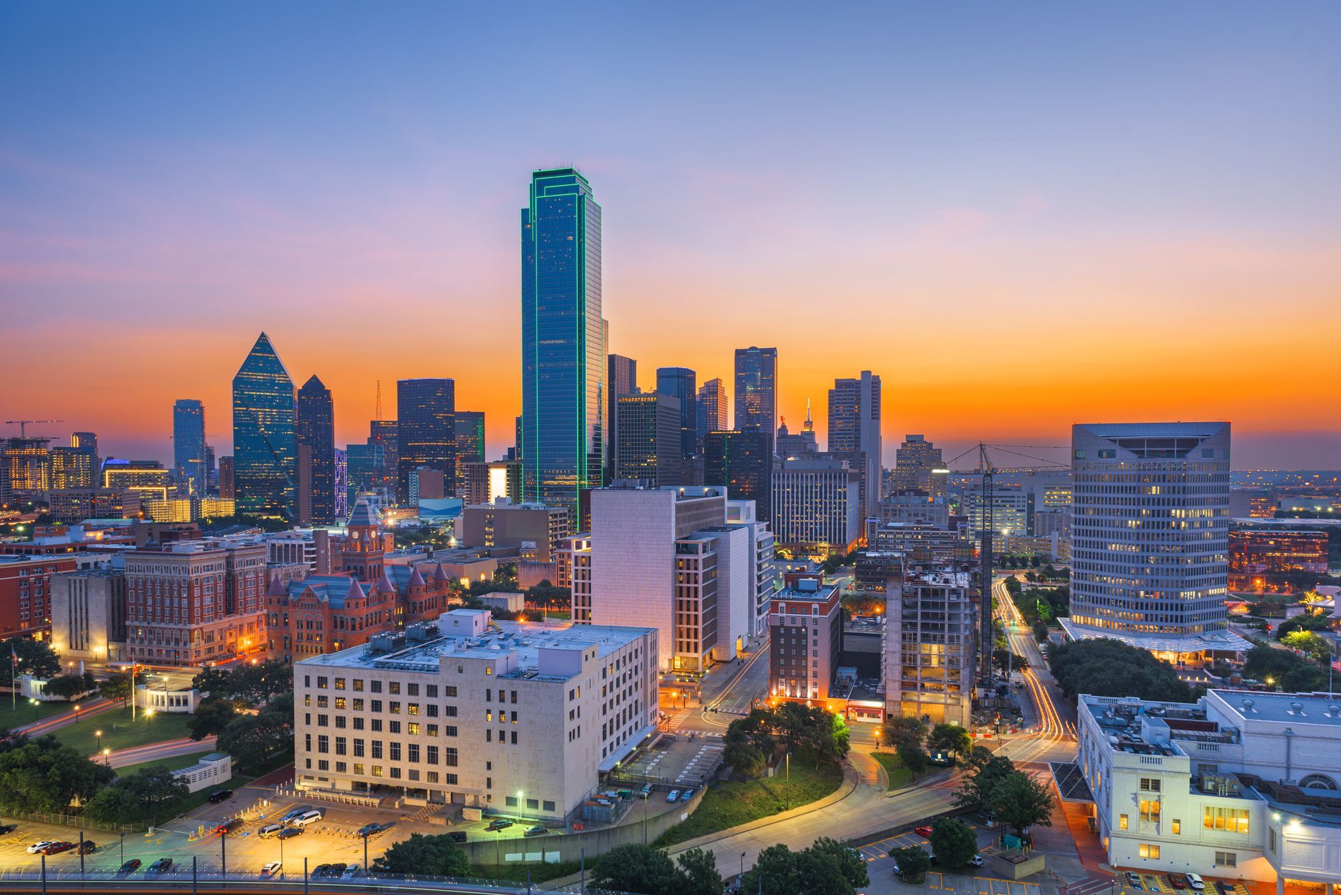 An aerial view of a city skyline at sunset.