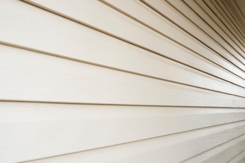 A close up of a white siding on a wall