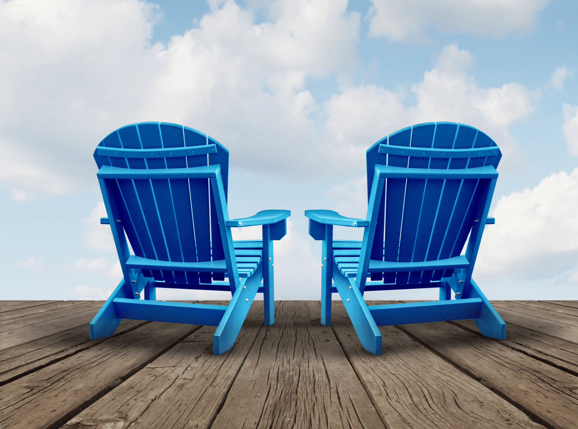 Two blue lawn chairs are sitting on a wooden deck.