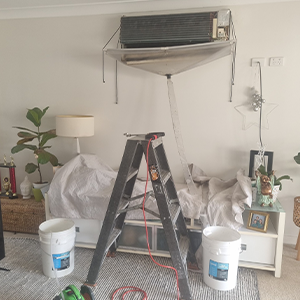 Cleaning Air Conditioner — Electrical, Heating & Air Conditioning in Thirroul, NSW