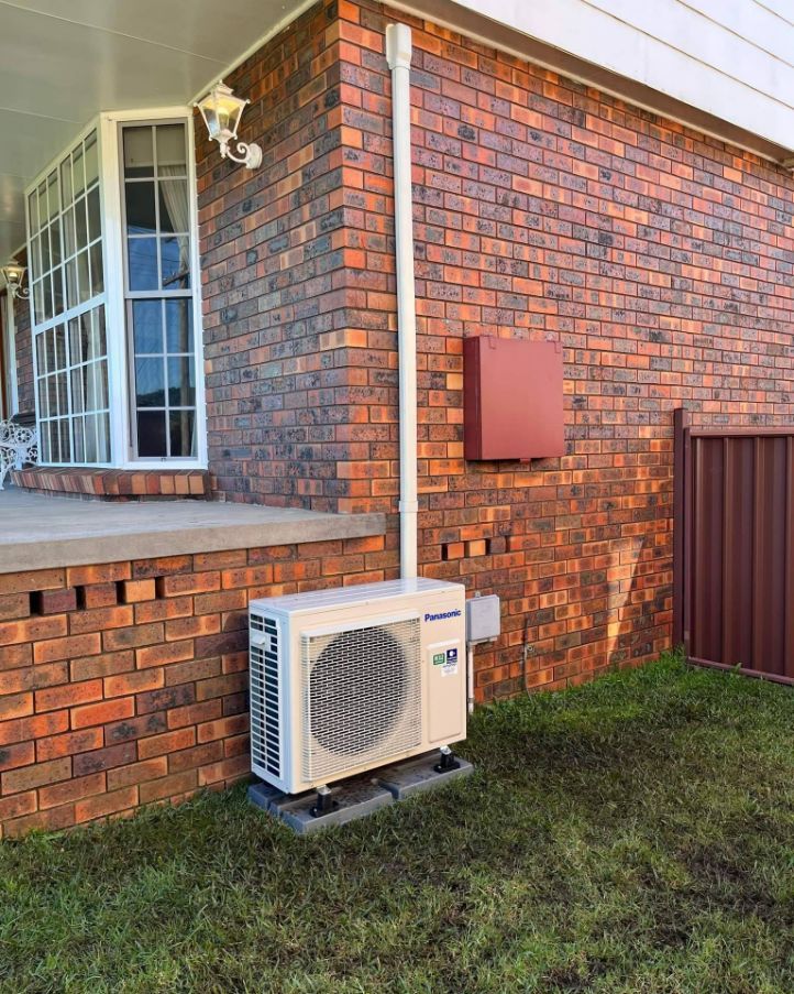Panasonic Premium Split System Installed Beside of The House — Electrical, Heating & Air Conditioning in Thirroul, NSW