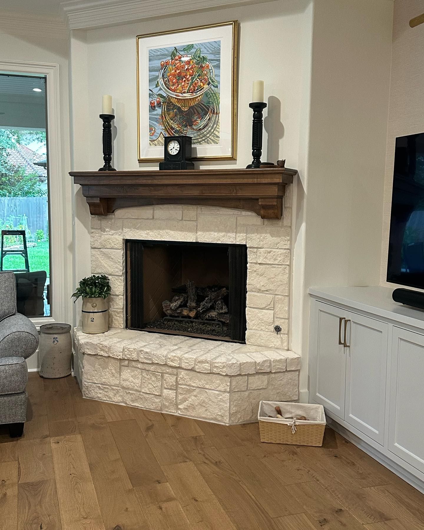 A living room with a fireplace and a television
