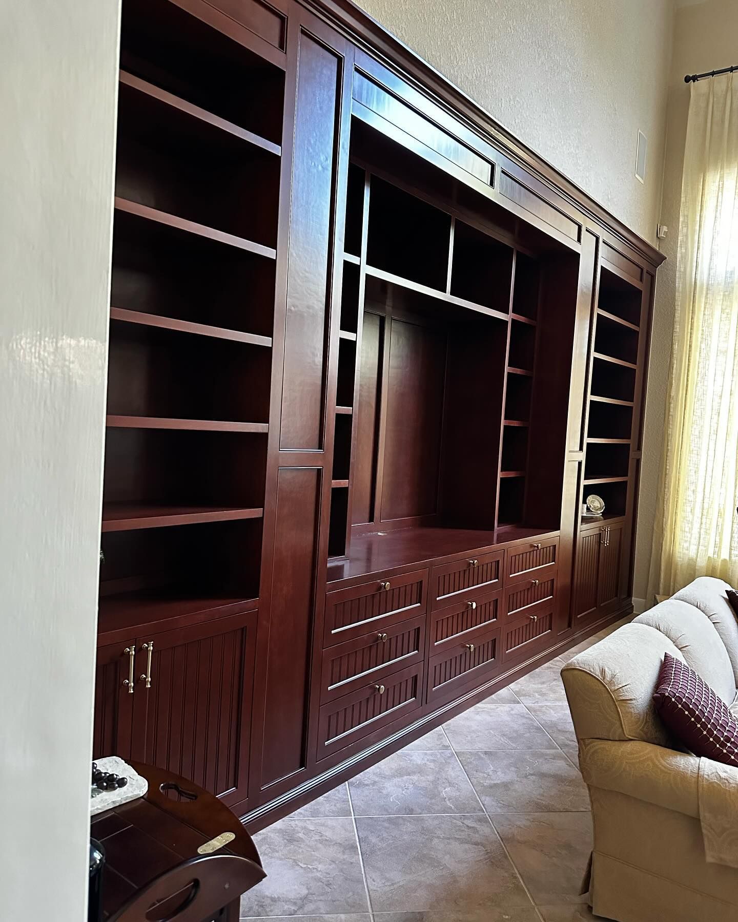 A living room with a large entertainment center and a couch