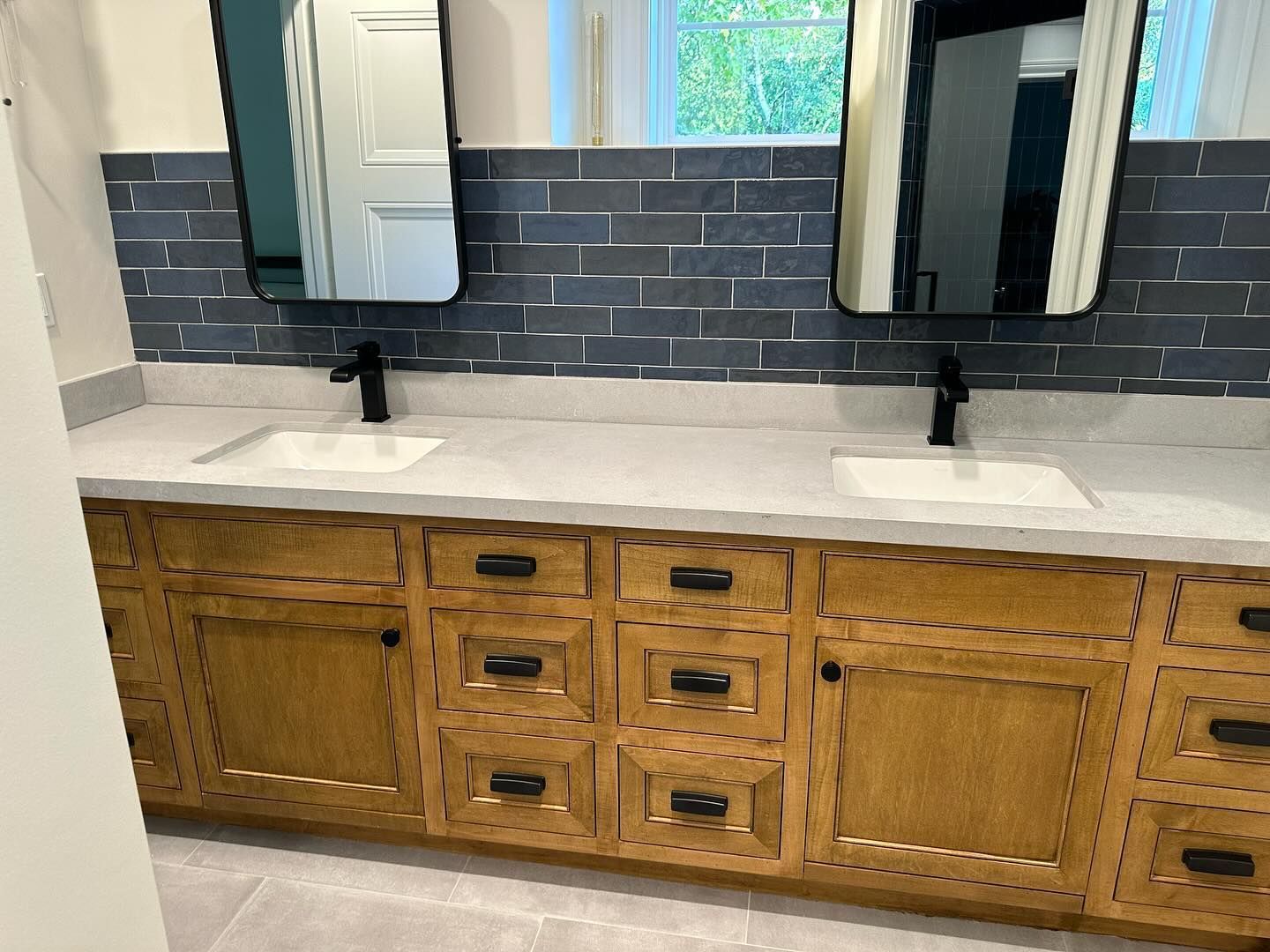 A bathroom with two sinks and two mirrors.