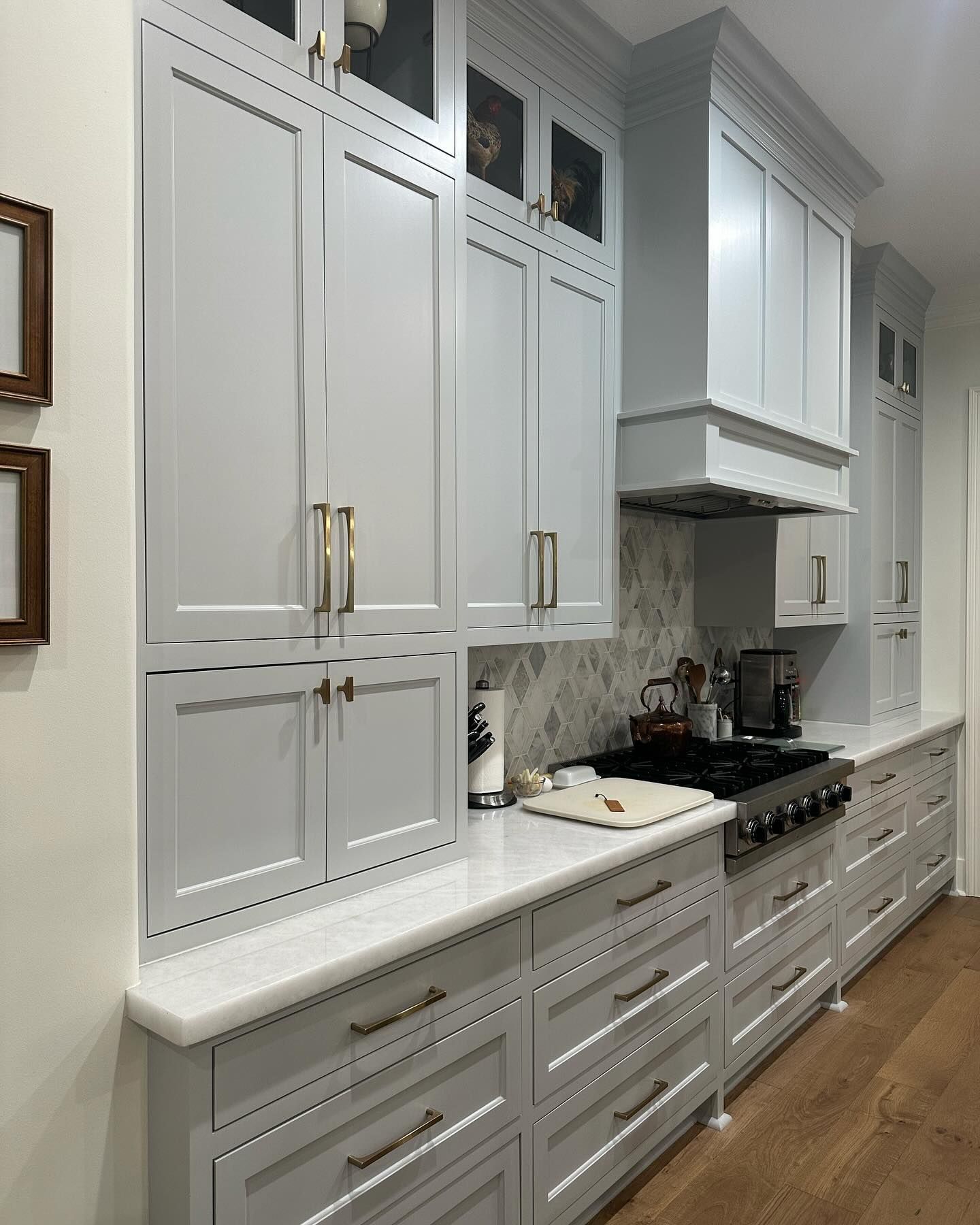 A kitchen with white cabinets and a stove top oven