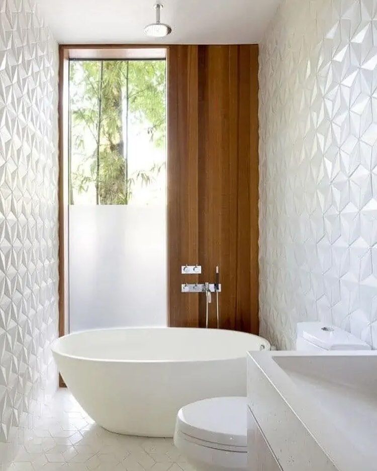 A bathroom with a tub , toilet , sink and window.