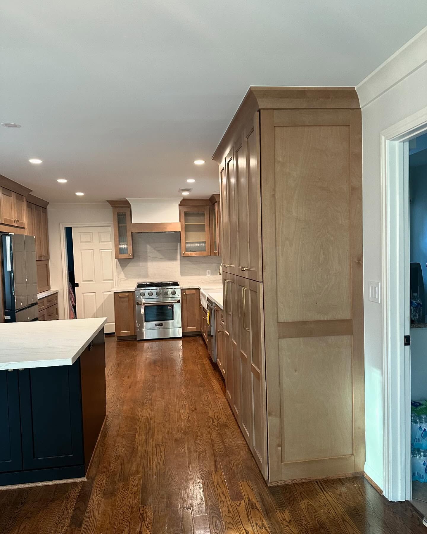 A kitchen with stainless steel appliances and wooden cabinets