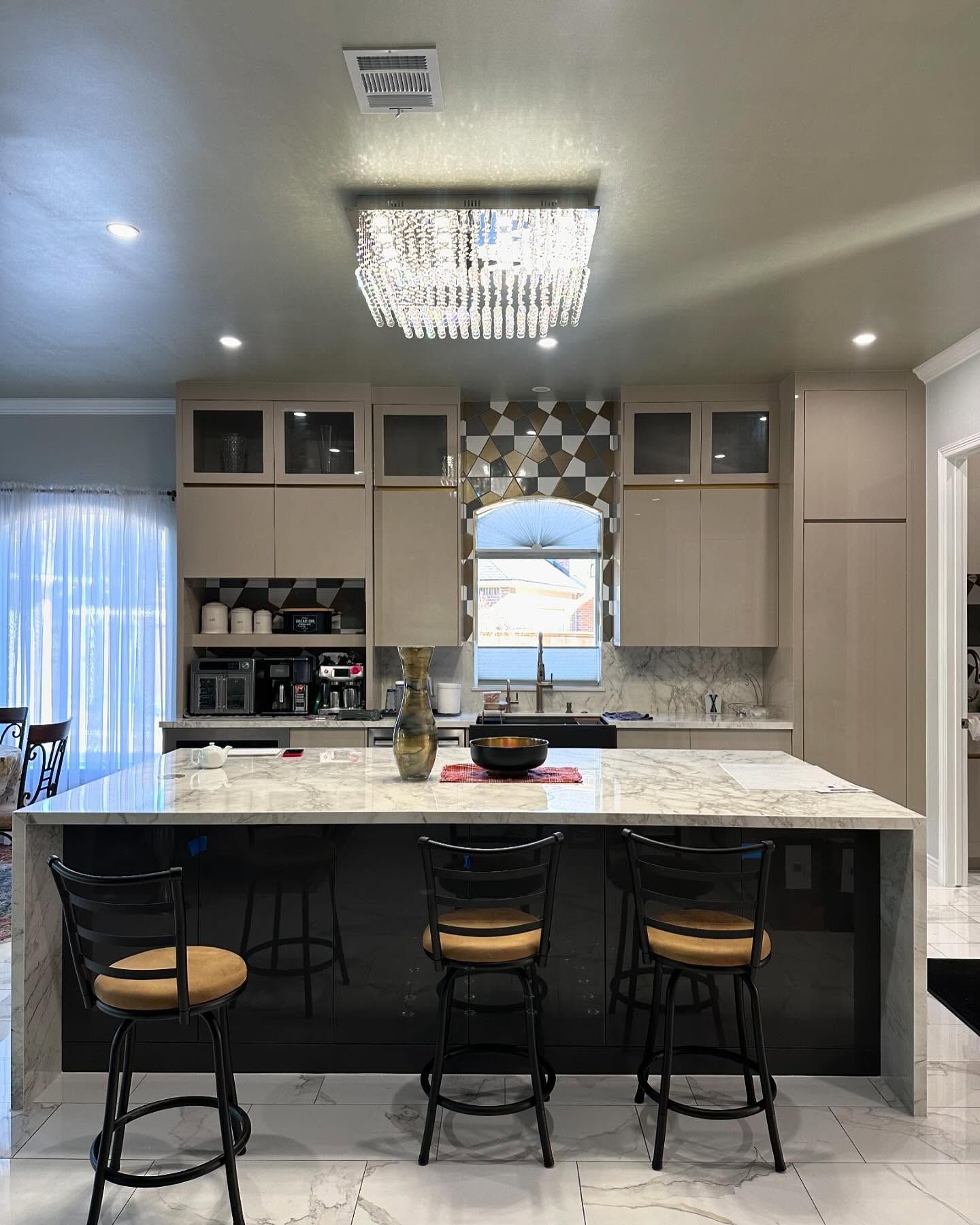 A kitchen with a large island and stools