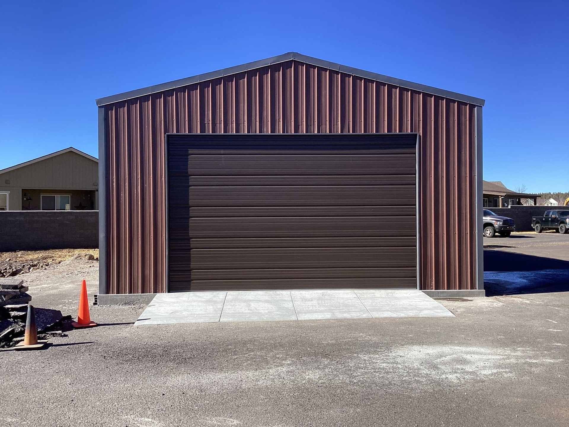 A brown metal garage with a brown garage door