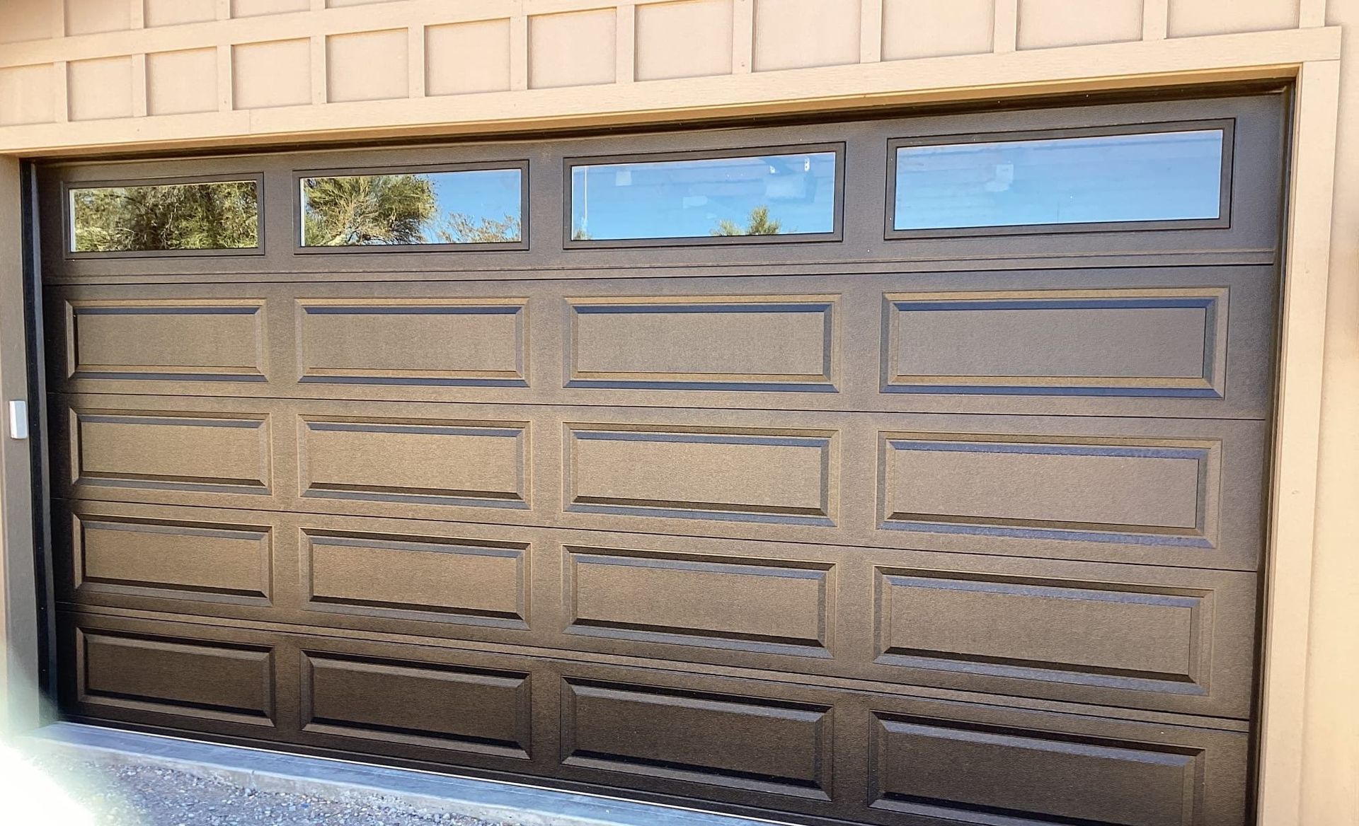 A brown garage door with a lot of windows on it