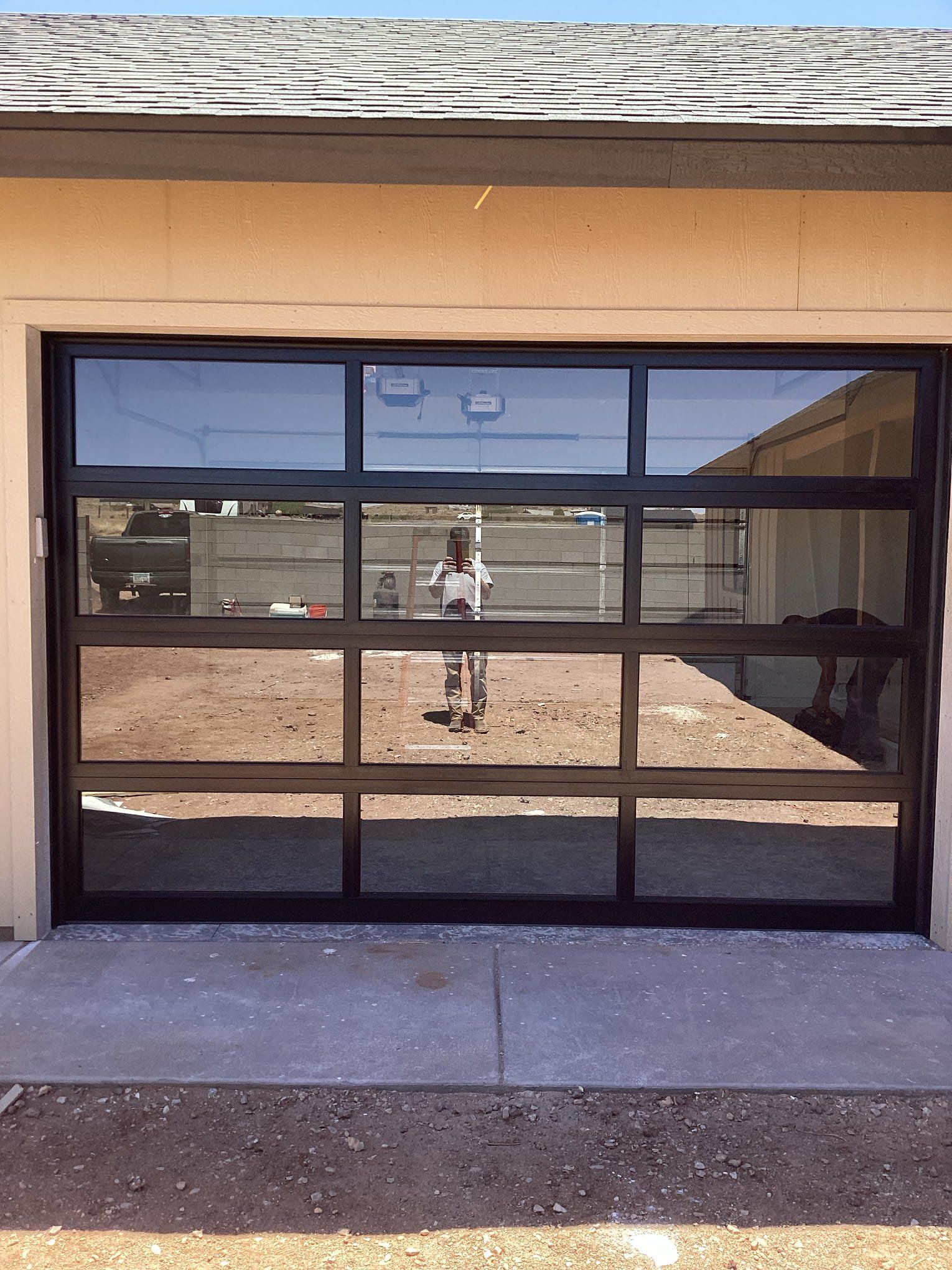 A woman in a wheelchair is standing in front of a garage door.