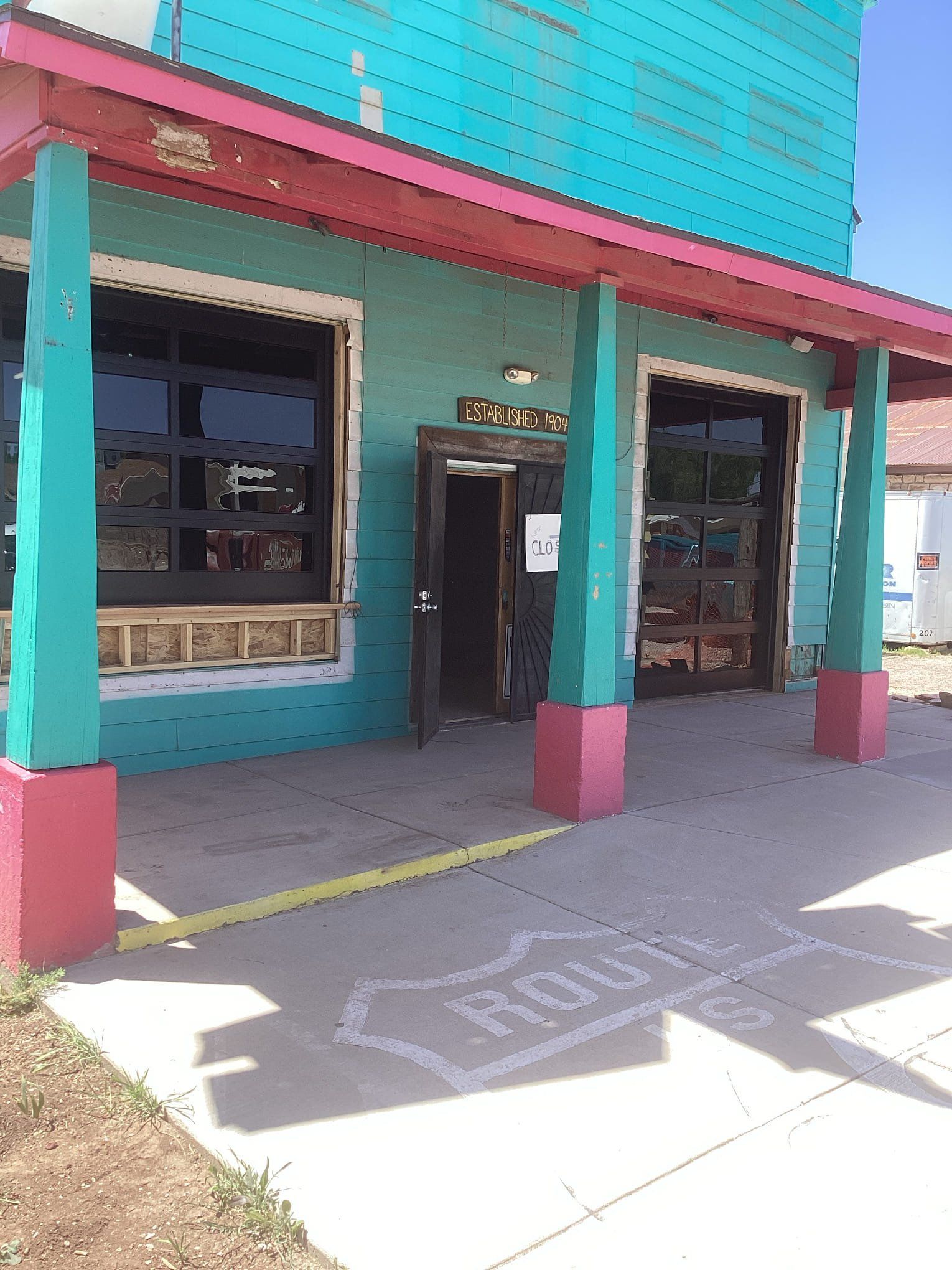 A blue and pink building with a sign that says ' faith ' on it