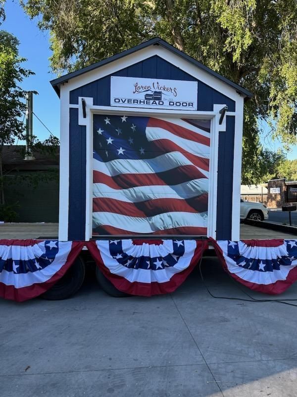 A blue and white shed with an american flag on it