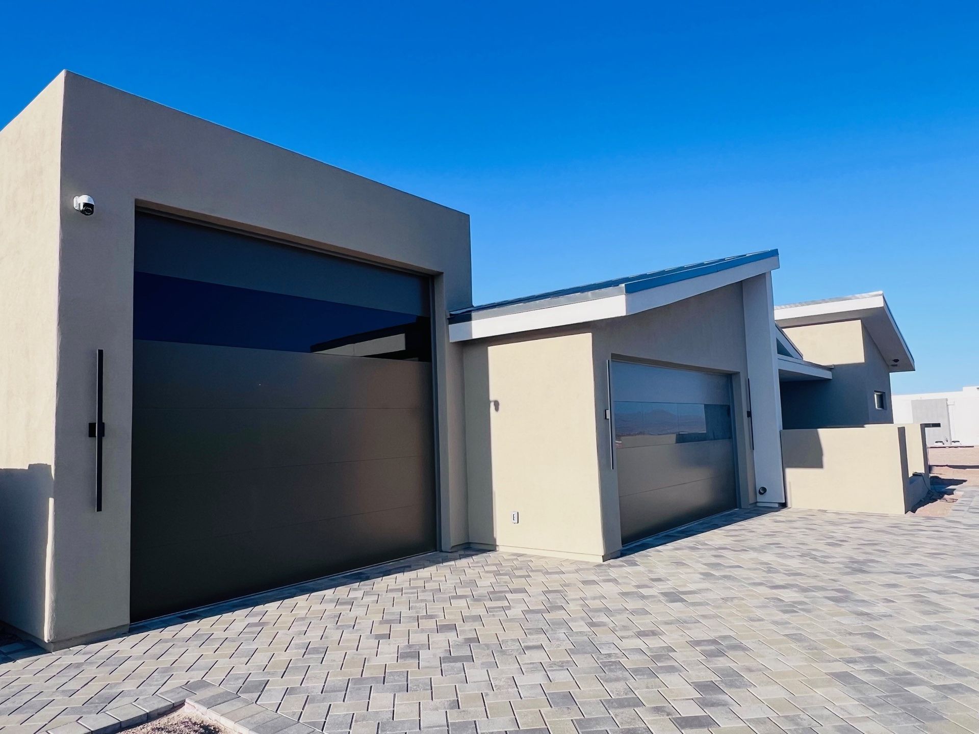A row of garage doors in front of a house