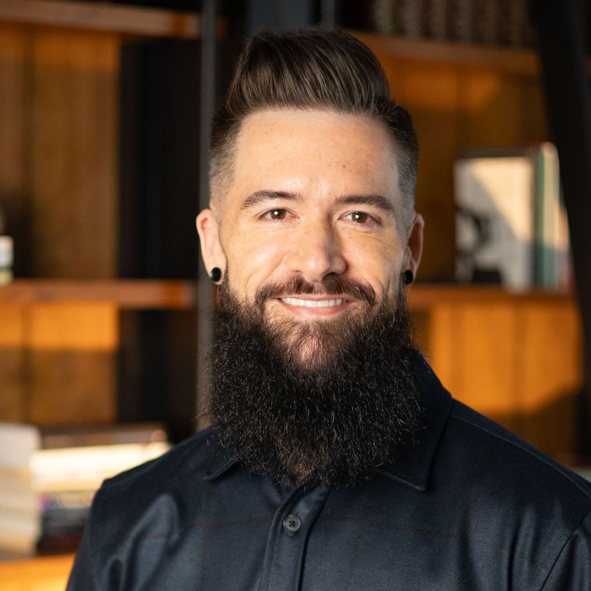 A man with a beard is smiling in a circle.