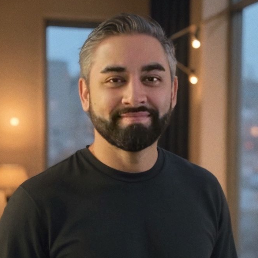 A woman with long blonde hair is smiling for the camera.