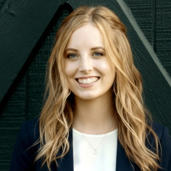 A woman with long blonde hair is smiling for the camera.
