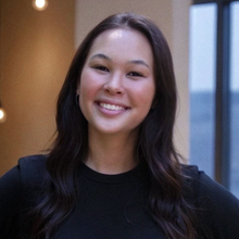 A woman with long blonde hair is smiling for the camera.