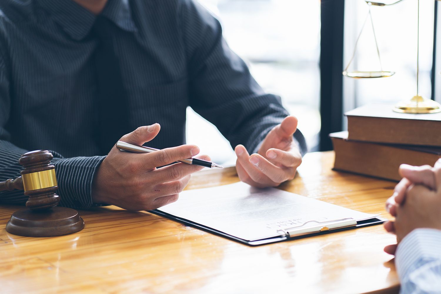 Attorney and client in court with bankruptcy lawyer discussing legal strategy and case details.