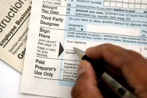 Signing Tax Form — Chicago, IL — Suburban Legal Group PC