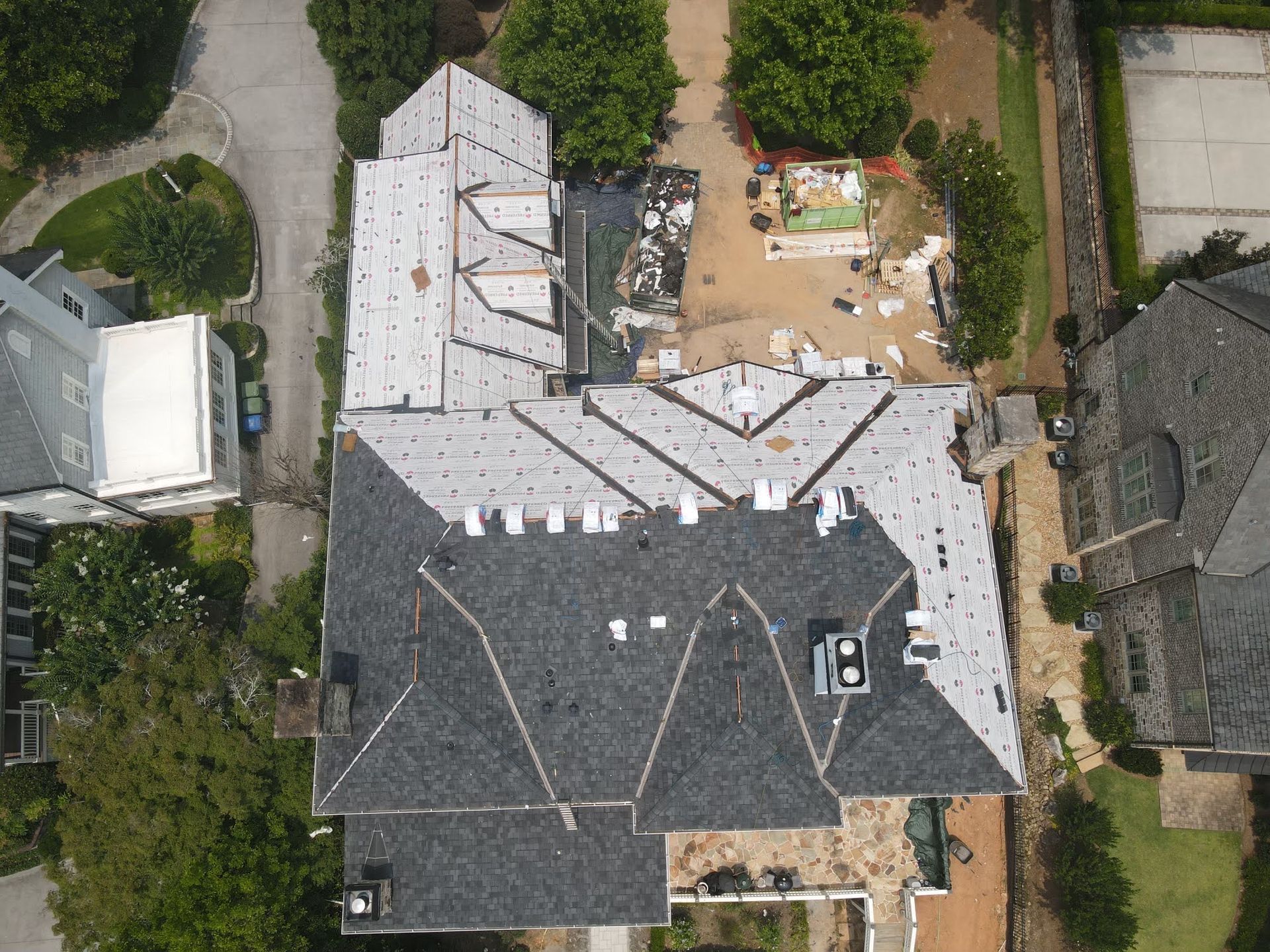 Merck Roofing specialists nailing down asphalt shingles for a residential project in Hall County, Georgia.