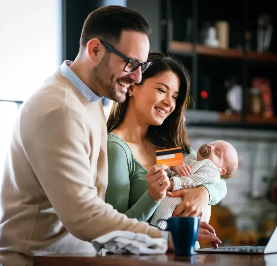Family using laptop and credit card at home in Atlanta, Georgia.