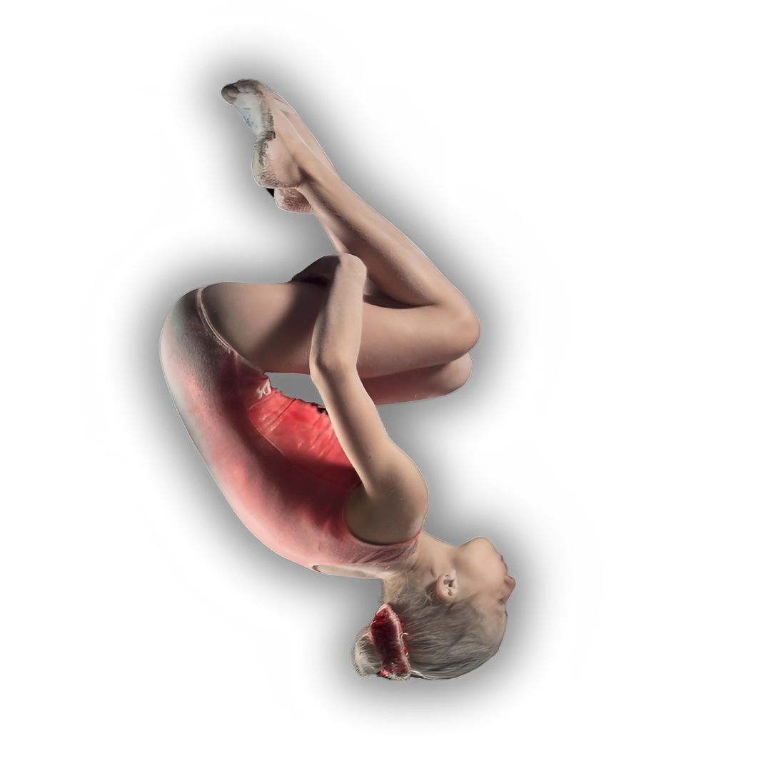 A young girl is doing a trick on a balance beam in a gym.
